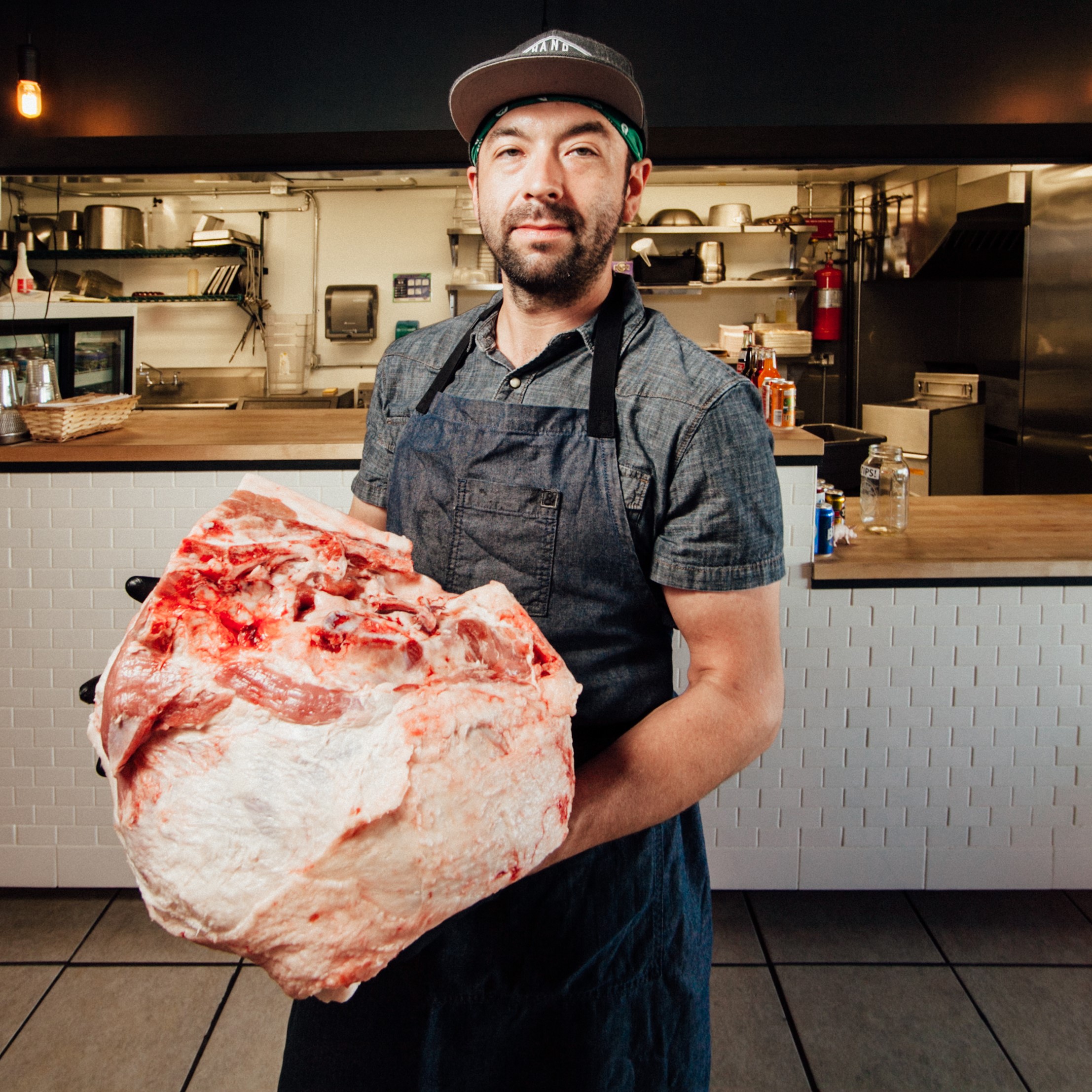 Lee Meisel holding large ham